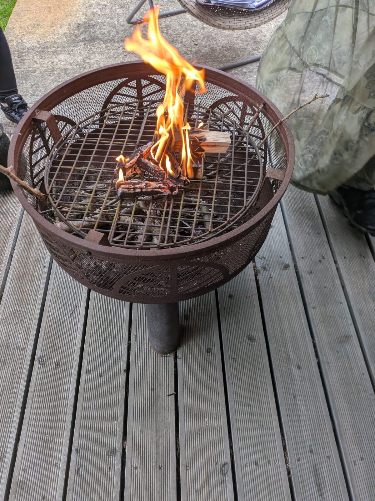 A small outdoor fire pit burning during a wellness gathering.