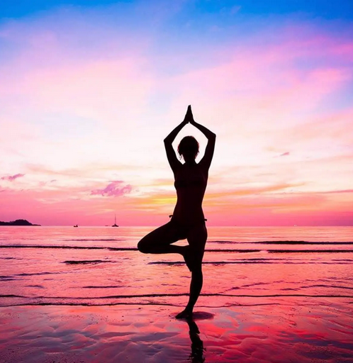 Yoga by the sea at sunset